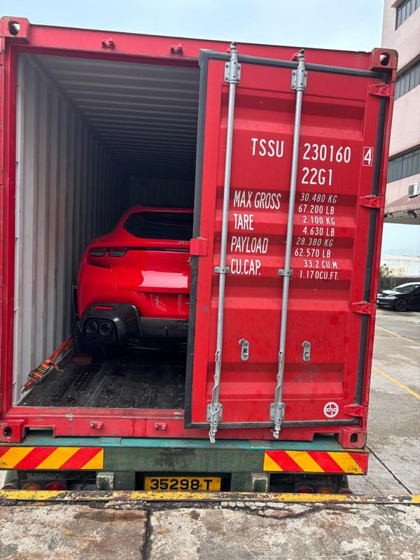 Red Ferrari Purosangue in a shipping container
