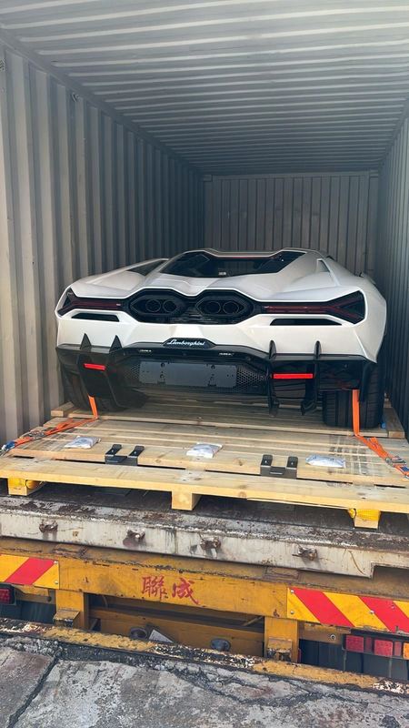 White Lamborghini Revuelto in a shipping container