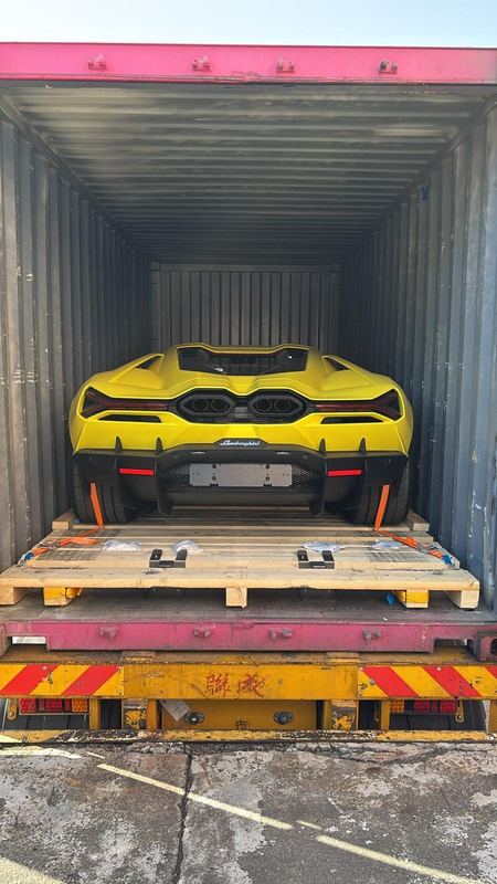Yellow Lamborghini Revuelto in a shipping container