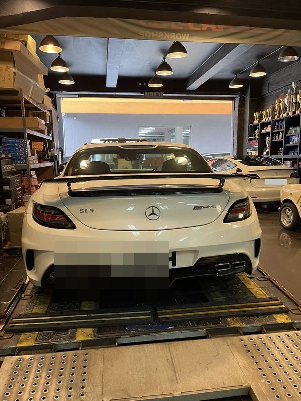 White Mercedes-AMG SLS on a vehicle transporter