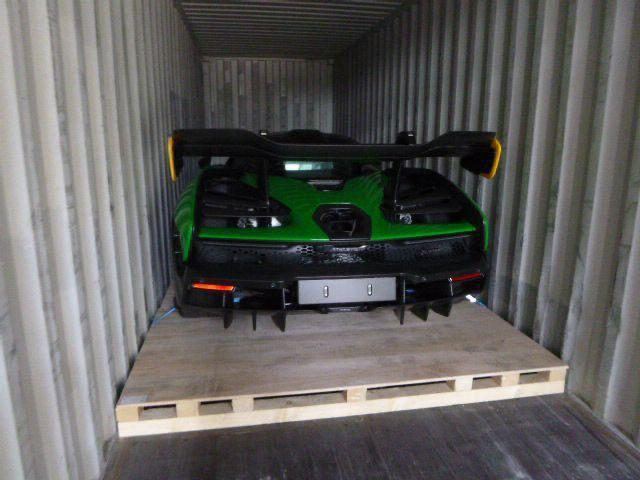 Green McLaren Senna inside a shipping container