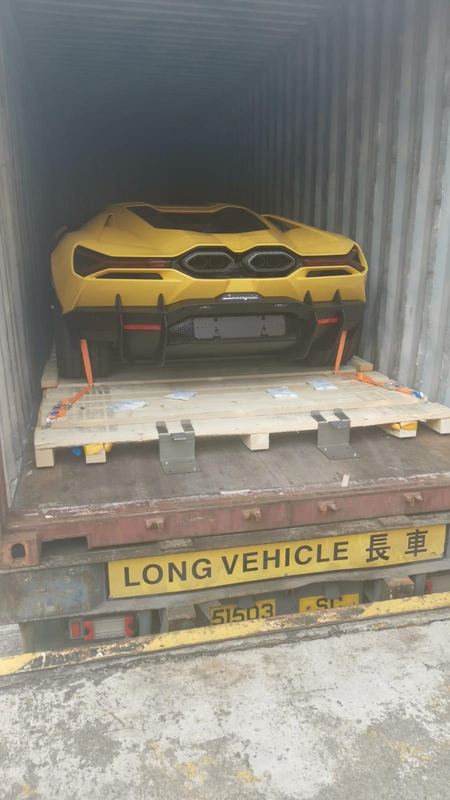 Yellow Lamborghini Revuelto loaded for shipping