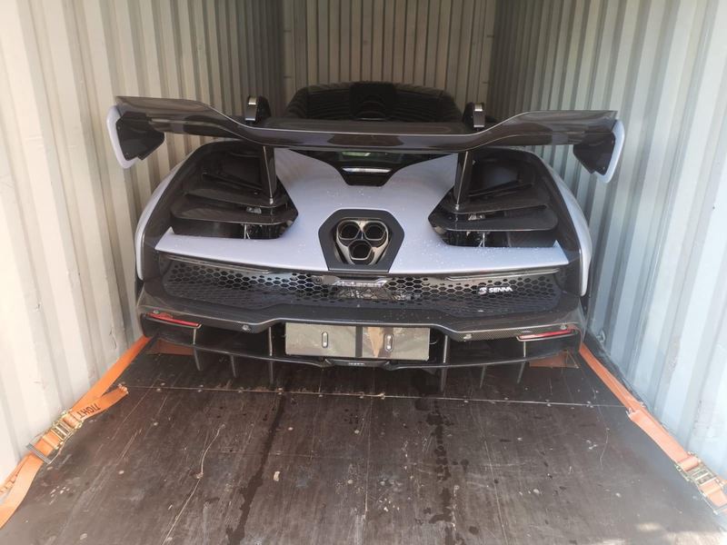 Silver McLaren Senna inside a shipping container