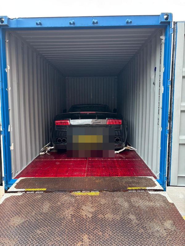 Black Lamborghini Gallardo in a shipping container