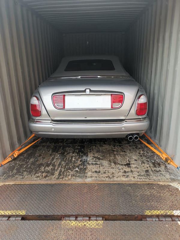 Silver Rolls-Royce convertible in a shipping container